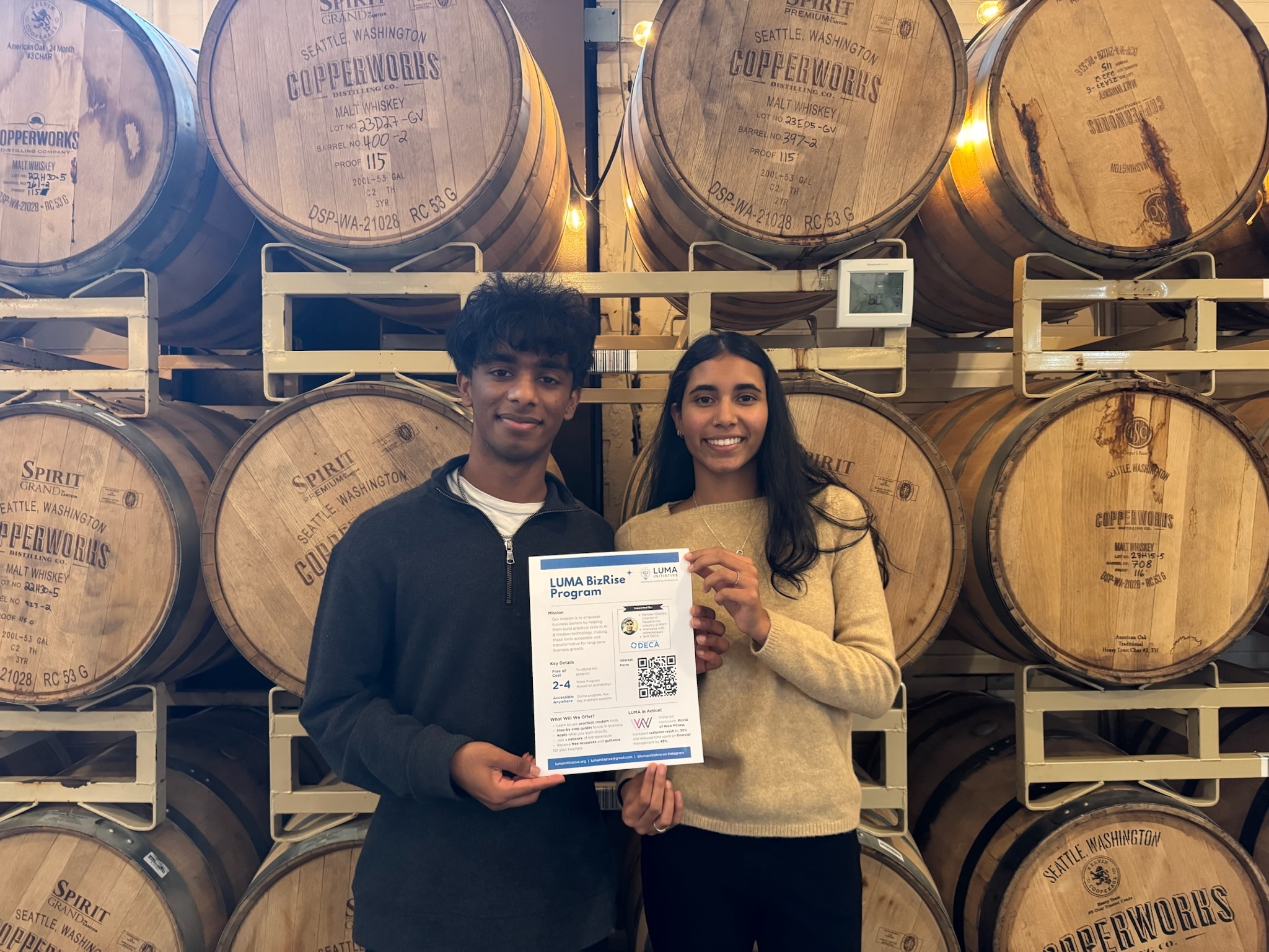 LUMA BizRise team members holding program materials